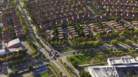 High-angle aerial view of traffic on a road through the San Carlos de Apoquindo Stock Footage 332559300