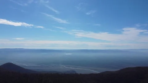 High-Angle Aerial View of a Vast Misty River Valley. A sweeping panoramic d.. Stock Footage 332004766