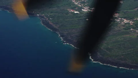 High-Angle Aerial View of a Volcanic Coastal Village and Traditional Vineyard Stock Footage 335010502