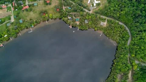 High Angle Aerial View of Waterfront Resort Cottages and Horse Arena on Lake Stock Photos