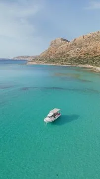 High angle aerial view of white motor boat anchored in clear turquoise wate.. Stock Photos