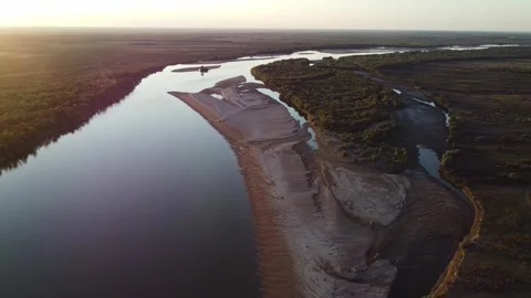 High angle aerial view of winding Syr Darya river with sandy banks and forest Video stock 335079726