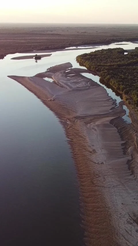High angle aerial view of winding Syr Darya river with sandy banks and forest Stock Footage 336686911