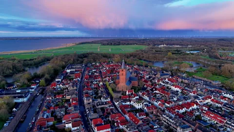High angle aerial wide shot of a historic Dutch town with red roof houses Stock Footage 338252834