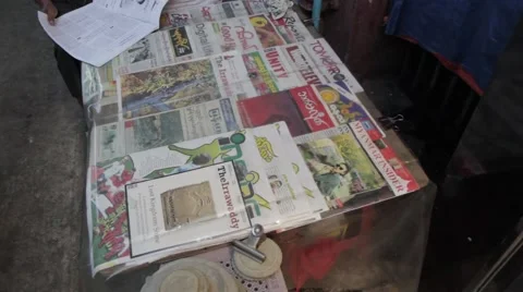 High Angle Asian Newspaper Stand, Man Reading (Yangon/Burma) Stock Footage 56632596