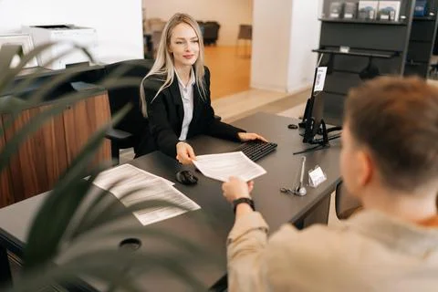 High-angle back view of female manager talking about business tasks with male Stock Photos