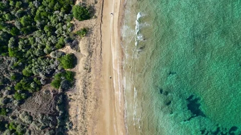 High Angle Bird's Eye View of Clear Ocean Waters Lapping on Wild Sandy Shore Stock Footage 347816809