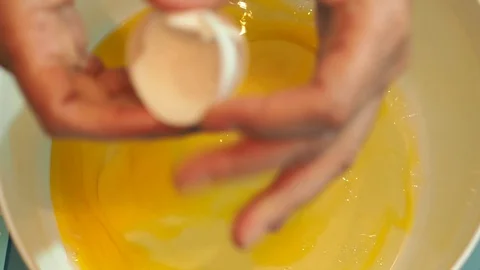 High angle of breaking an egg into a bowl Stock-Footage 128002698