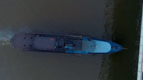 High angle of a cargo boat moving under the bridge. Stock Footage