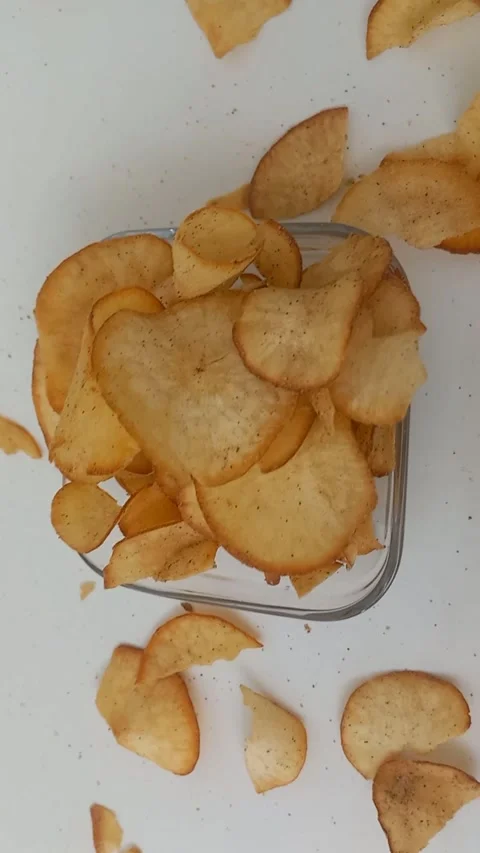 High Angle Cassava Chips in Glass Bowl Camera Tilt Up Close Up Stock Footage 342285215
