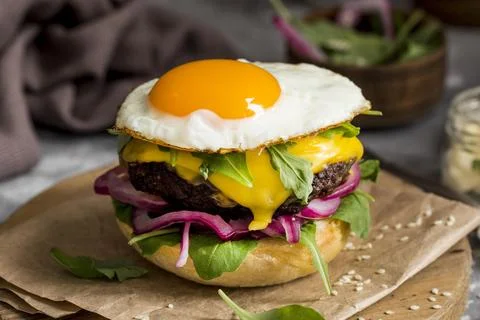 High angle cheeseburger with fried egg cutting board Stock Photos