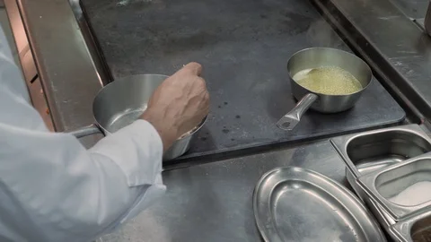 High Angle. Chef hands stir pieces of meat in frying pan made of stainless steel Stock Footage 88674037