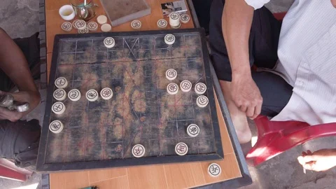 High Angle, Chinese Chess, Xiangqi. Asiatic people play in a bar on a wood Stock Footage 115524372