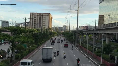 High angle of city traffic with LRT train passing on the side Parañaque 4K Vídeos de archivo 337950362