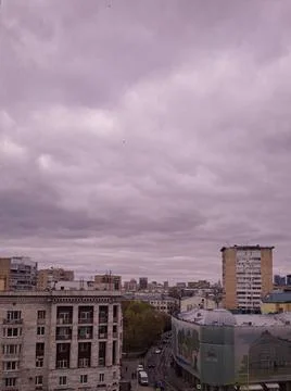 High angle cityscape view under dramatic purple clouds. 스톡 사진