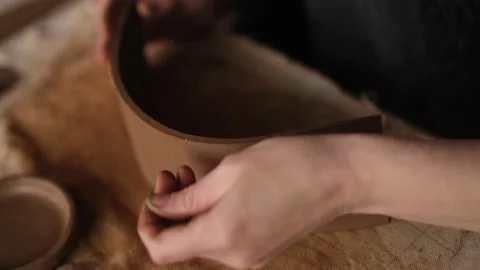 High angle close up of ceramic artist cuts clay for teapot in the studio Stock Footage 236372429