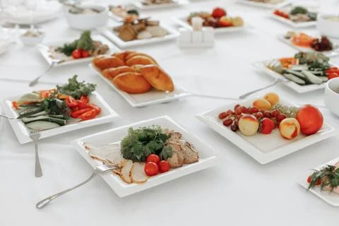 High angle close-up of diverse cold appetizers including meat rolls, fresh Stock Photos