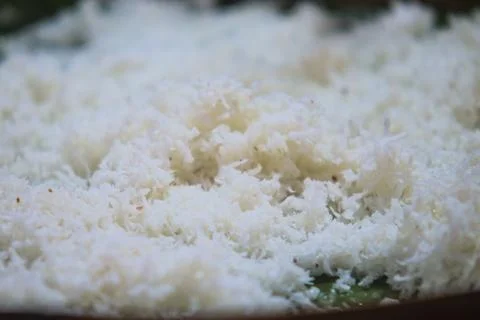 High Angle Close Up of Freshly Grated White Coconut Flakes Spread Out Stock Photos