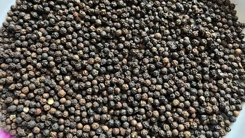 High-angle close-up of a large pile of dried black peppercorns Stock Footage 328633498