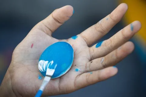 High Angle Close Up of Paintbrush Blending White Accent Line on Blue Painte.. 写真素材