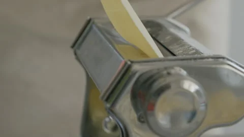 High angle close up of pasta maker dough rolling through Stock Footage 256978781