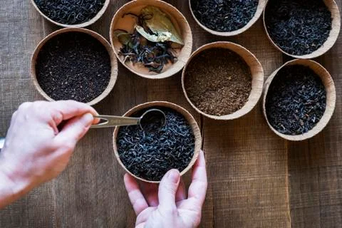 High angle close up of a selection of tea leaves in small wooden bowls. Stock Photos