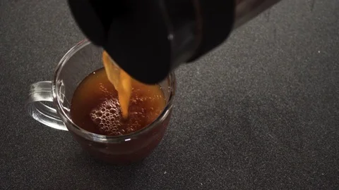 High angle close shot of coffee pouring from french press into cup Stock Footage 82444628