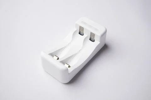High-angle, close-up shot of an empty white universal battery charger with .. Stock Photos