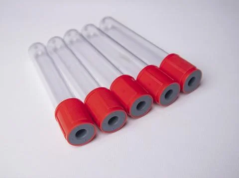 A high-angle, close-up shot of five empty medical blood collection tubes wi.. Stock Photos