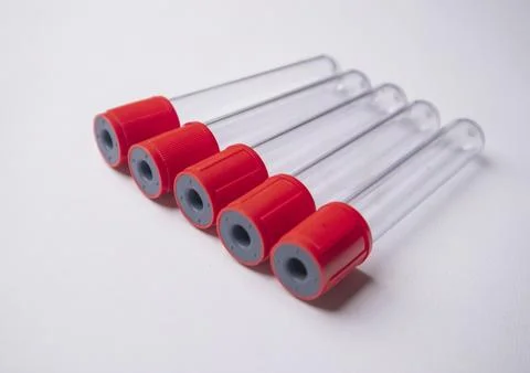 A high-angle, close-up shot of five empty medical blood collection tubes wi.. Stock Photos