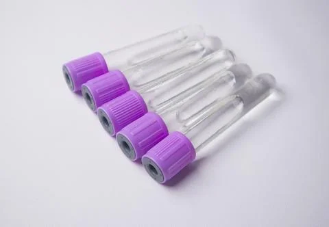 A high-angle, close-up shot of five empty medical blood collection tubes wi.. Stock Photos