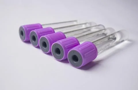 A high-angle, close-up shot of five empty medical blood collection tubes wi.. Stock Photos