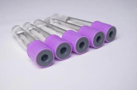 A high-angle, close-up shot of five empty medical blood collection tubes wi.. Stock Photos