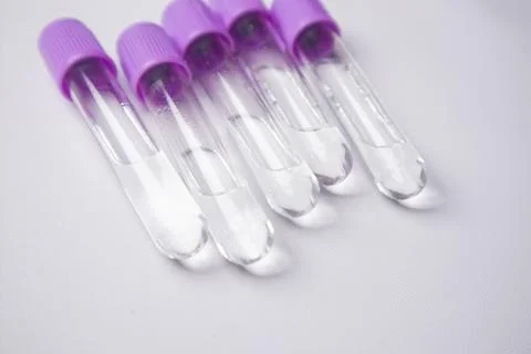 A high-angle, close-up shot of five empty medical blood collection tubes wi.. Stock Photos