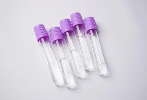 A high-angle, close-up shot of five empty medical blood collection tubes wi.. Stock Photos