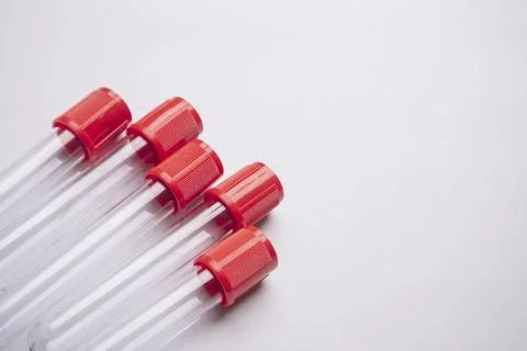 High-angle, close-up shot of four empty medical blood collection tubes with.. Stock Photos