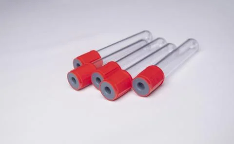 High-angle, close-up shot of four empty medical blood collection tubes with.. Stock Photos