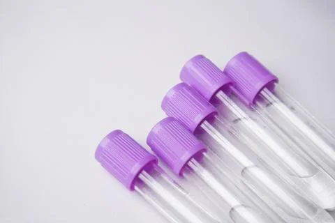 High-angle, close-up shot of four empty medical blood collection tubes with.. Stock Photos