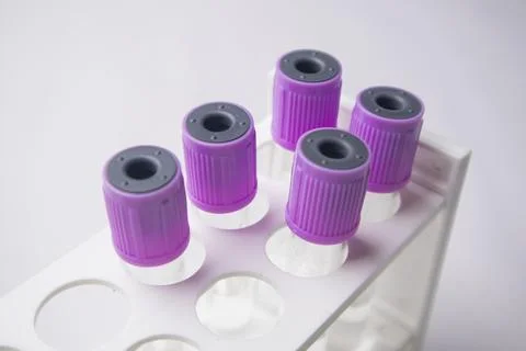 High-angle, close-up shot of four empty medical blood collection tubes with.. Stock Photos