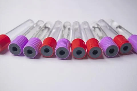 A high-angle, close-up shot of nine empty medical blood collection tubes wi.. Stock Photos