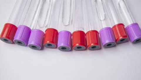High-angle, close-up shot of ten empty medical blood collection tubes with .. Stock Photos
