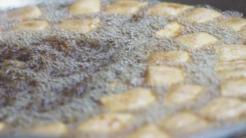 High angle close up of square tofu pieces deep frying in bubbling hot cooki.. Stock Footage 344809190