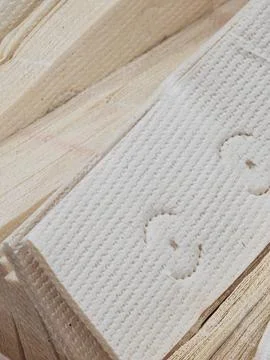 High-Angle Close-Up of Stacked Embossed White Fibrous Material Texture Fotos Stock