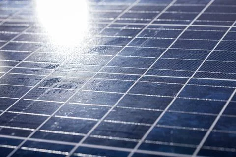 High angle close-up of sunlight falling on solar panel with white grid pattern, Stock Photos