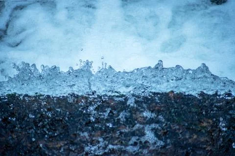 High angle close up of water leaping over the edge of a waterfall Stock Photos