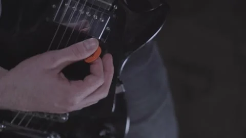 High angle close up of young man practicing electric guitar by himself. Video stock 240184658