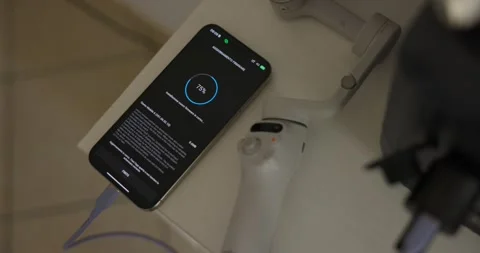 High angle closeup of phone and Insta 360 flow pro syncing, lying on table Stock Footage 293598482