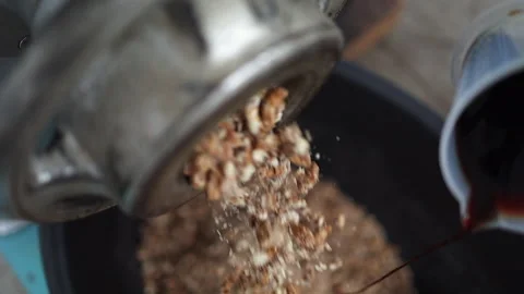 High angle closeup: Syrup added to ground nuts, dates from extruder Stock Footage 305133502