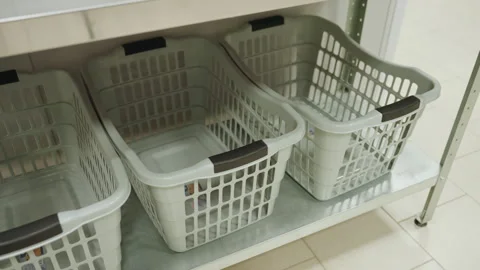 High Angle Clothes Baskets On Shelf In Clean Laundry Room Stock Footage 318848551