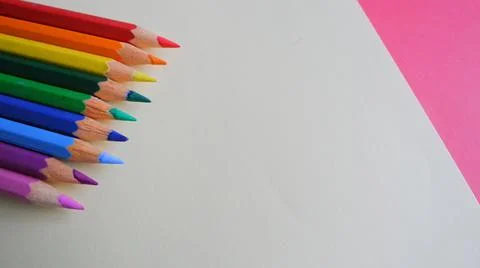 High angle of colorful sharp pencils on a sheet of paper with space for text Stock Photos